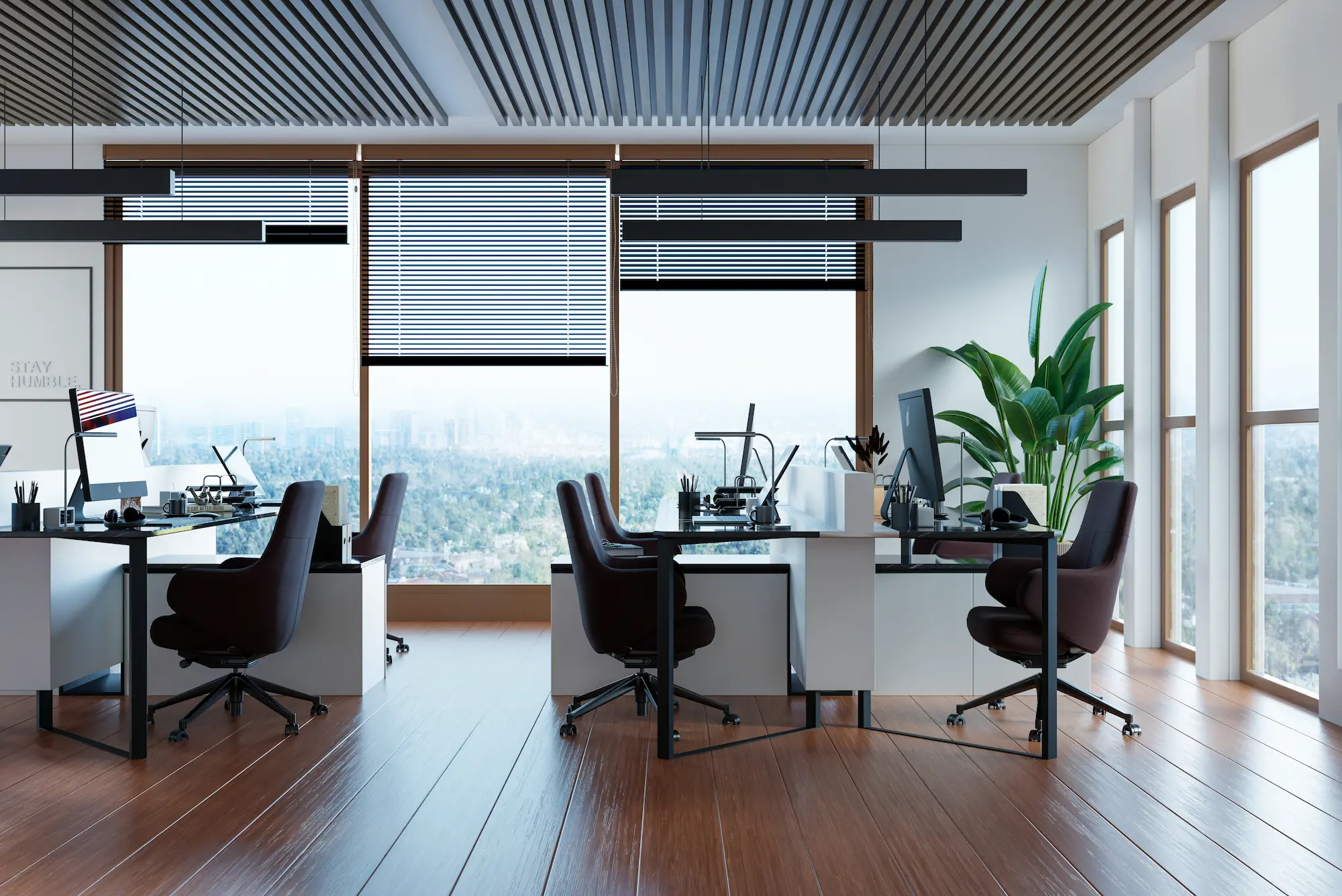 A bright and airy open office space features modern desks and rolling chairs.